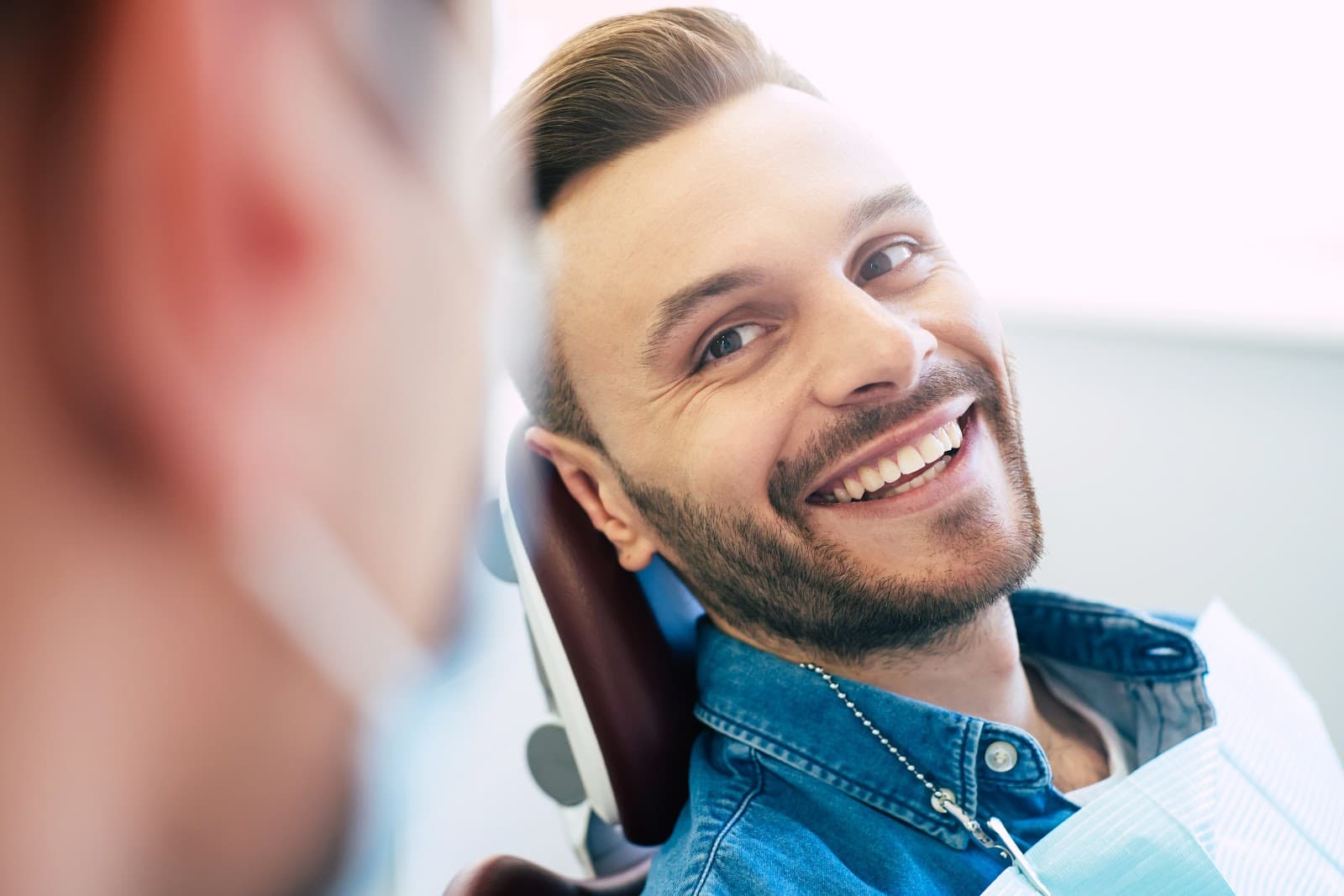 Man smiling after dentist explains that his oral hygiene is in order.